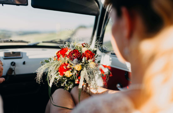Mariée dans la voiture avec son bouquet